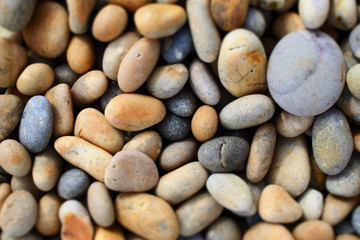 Fototapeta na wymiar Rounded pebbles on beach