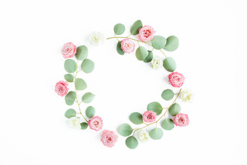 Round wreath frame eucalyptus branches and rose flowers isolated on white background. Flat lay, top view.  Floral frame. Wreath of flowers.