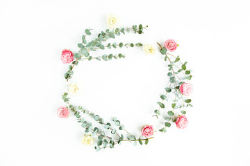 Round wreath frame eucalyptus branches and rose flowers isolated on white background. Flat lay, top view.  Floral frame. Wreath of flowers.