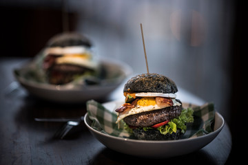 Black hamburgers with egg and bacon