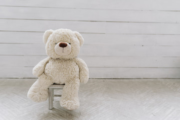 Teddy bear toy on a small toy chair