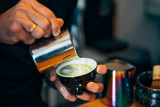 Close-up of barista preparing tea in a cafe