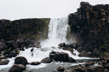 Waterfall in the stones. Waterfall in Iceland.