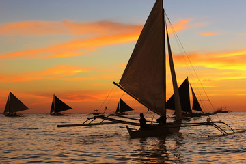 Fototapeta na wymiar Scenic sunset over Boracay coast with sailboats, Philippines