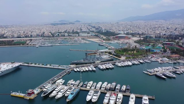 Aerial drone video of famous Flisvos Marina with mega yachts and sail boats docked, Athens riviera, Attica, Greece