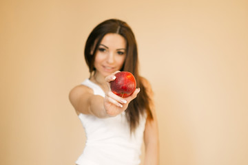  a young girl in a white T-shirt on a uniform beige background makes an emotion of happiness, rejoices, smiles, shows lashes