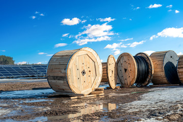 Wooden coils with a high-voltage cable for joining sections of solar panels