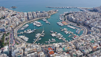 Obraz premium Aerial drone photo of famous busy port and safe dock of Bay of Zea or Pasalimani (Pasha's harbour) in the heart of Piraeus, Attica, Greece
