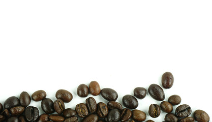 Many coffee beans on a white background with copy space for your text.