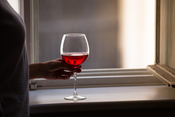 person at home drinking wine 