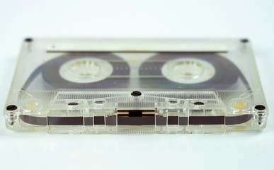 transparent audio cassette on white background.