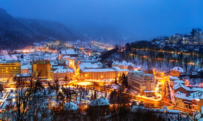 Obraz premium Aerial view of Brasov town, illuminated architecture of the city in winter season - Romania