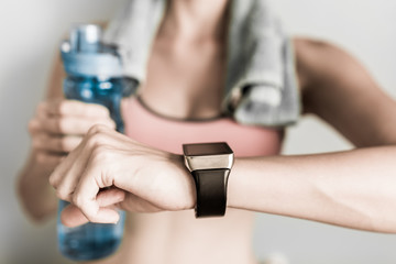 Fitness, technology, closeup of woman checking her smartwatch while working out
