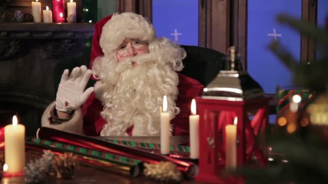 Santa Claus saying "Happy holidays!" and waving