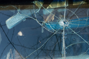 Old rusty and damaged antique car wreck in very poor condition on house yard.