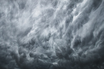 Obraz na płótnie Canvas Stormy rain clouds background. Dark sky. Dramatic Moody Thunder Storm. Climate Change weather environment background.