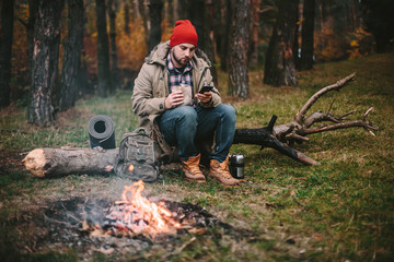 Young blogger photographer travel in mountain forest