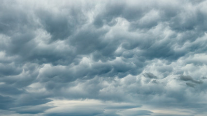 Stormy rain clouds background. Dark sky. Dramatic Moody Thunder Storm. Climate Change weather environment background.