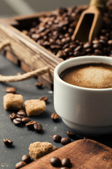 Black fried coffee beans on dark textured background