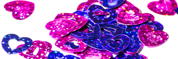 Hearts background. Lots of glittery pink and purple hearts isolated on white. Romance, love, caring, romantic concept background. Arts and crafts. Heart pattern.