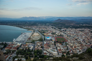 Obraz premium small European old town on north sea bay with buildings stadium and harbor, cloudy rainy gray autumn season weather time, aerial photography