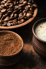 Black fried coffee beans on dark textured background