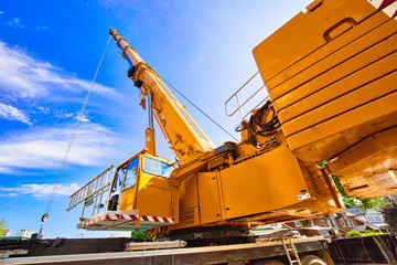 Mobile crane at work at downtown construction site
