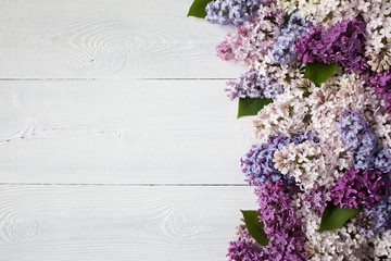 Colored lilac on a white wooden background