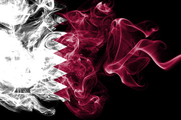 National flag of Qatar made from colored smoke isolated on black background. Abstract silky wave background.
