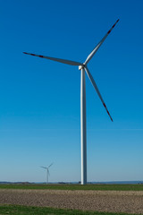 Field with windmills for electric power. Clean energy produced by the wind. Extraction of energy from the air