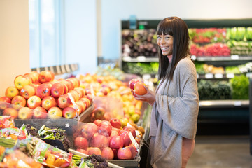 African American woman shopping for produce in grocery store