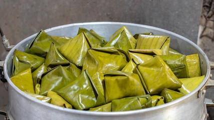 Thai sweets triangle wrapped with banana leaves.