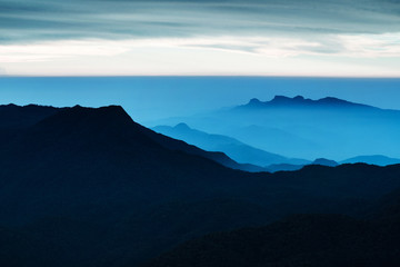 Fototapeta na wymiar Blue landscape with mountains and morning fog. Cloudy sunrice