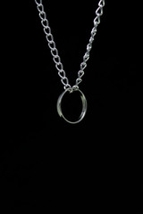 Silver ring hanging on chain