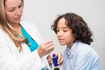 Doctor giving a child homeopathic medicine