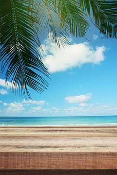 Tropical beach background with palm tree and empty wooden, Summer.