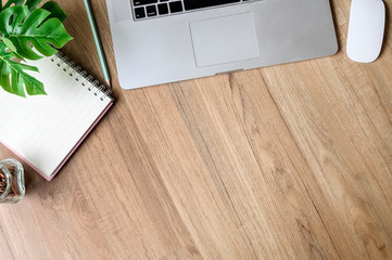 Wood office desk table with laptop, notebook and supplies. wooden desk and copy space.