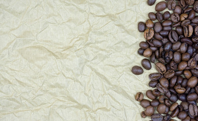 Obraz na płótnie Canvas Coffee Beans On Old wrinkled Parchment Paper, horizontal