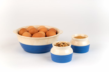 Farm Fresh Organic Free Range Eggs, Walnuts, Cinnamon, Organic Sugar in Blue and White Bowls. Farm to Table.