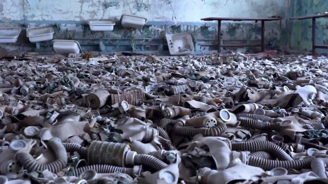 Slow Motion Tilt Down Shot of Abandoned Soviet Gas Masks in Chernobyl