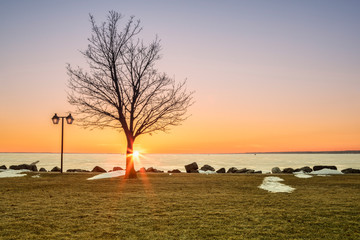 Spring View of Sylvan Beach on Oneida Lake during Sunset while the Lake is Still Frozen.