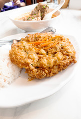 Rice with fried eggs and spicy pork ribs soup
