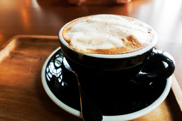 Hot coffee on a wooden table