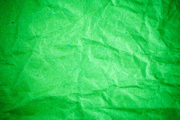 Green vignette crumpled paper.