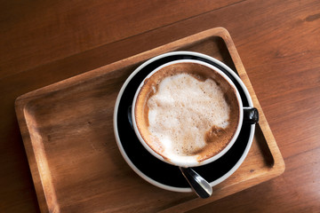 Hot coffee on a wooden table