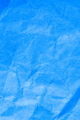 Fototapeta na wymiar Blue vignette crumpled paper.