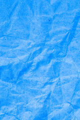 Blue vignette crumpled paper.