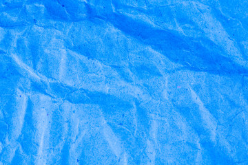 Blue vignette crumpled paper.