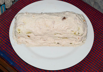 Cake with cream on a white plate