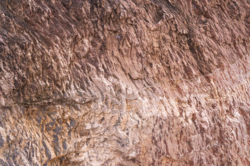 Stone texture background with unique pattern. Brown and white dirty rock texture. Rock surface abstract background. Natural stone background. Rough stone floor. Grunge and rust rock texture.